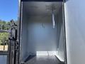 Interior of a 2011 International 4300 cargo area featuring a metal support with a hanging cable on the left side and a clean, empty floor