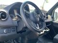 Interior view of a 2022 Mercedes-Benz Sprinter showcasing the steering wheel dashboard and control panel