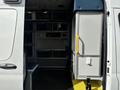 A 2020 Mercedes-Benz Sprinter 2500 with an open side door revealing a spacious interior that features storage units and seating