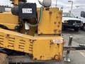A yellow 2015 Vermeer Corporation BC1200XL industrial wood chipper with visible wear and a battery disconnect label