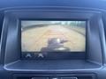 Backup camera display showing guidelines for a 2017 Chevrolet Colorado with a view of a road ahead