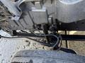 A close-up view of the undercarriage of a 2014 Hino 195 showcasing various mechanical components and wiring connected to the chassis