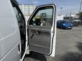 A 2008 Ford Econoline van with an open driver side door showcasing the interior and door handle