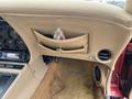 Interior view of a 1970 Chevrolet Corvette featuring a beige dashboard storage pocket and dashboard controls with a stereo system visible