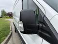 A white 2017 Ford Transit van with raindrops on the side mirror and a close-up view of the mirror's design and mounting