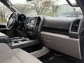 Interior view of a 2015 Ford F-150 showing dashboard controls seating and center console