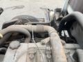 Close-up view of the engine compartment of a 2005 Toyota Toyoace showcasing various hoses and components with some signs of wear and dirt