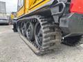 A 2004 Bombardier SW48 featuring large rubber tracks with multiple tread patterns designed for traction on various surfaces