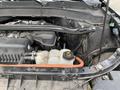 Close-up of the engine bay of a 2021 Ford Explorer showing the engine components and various fluid reservoirs