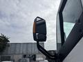 Close-up of the side mirror of a 2020 Lion Lion6 featuring a rectangular reflective surface and an orange indicator light on the side