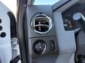 Interior panel of a 2010 Ford F-450 showing air vent and control knobs for lights and other functions