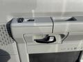 Interior door panel of a 2013 Ford E-350 Super Duty featuring door handle and control buttons for windows and locks