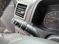 A close-up view of the turn signal and wiper control stalk on the steering column of a 2012 GMC Canyon showing various control icons and indicators