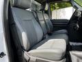 Interior view of the front seats of a 2016 Ford F-550 with gray upholstery and ample seating space