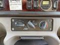 Dashboard controls of a 2012 Freightliner M2 106 featuring knobs for climate and air conditioning settings