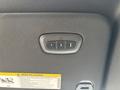 Overhead control panel featuring three buttons and a warning label in a 2021 RAM 1500
