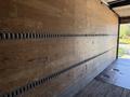 Interior of a 2012 Freightliner M2 106 truck with wooden walls and horizontal tracks for cargo securing