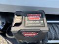 A WARN M8000-S contactor control unit mounted on a vehicle with a winch showing the logo and model clearly visible