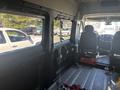 Interior view of a 2020 RAM ProMaster 3500 showing seating area and dashboard with minimal furnishings and a focus on the driver's seat