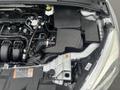 An engine compartment of a 2018 Ford Focus showing components like the air intake manifold battery and various fluid reservoirs