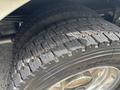 Close-up of a tire from a 2020 Freightliner MT45 featuring a deep tread pattern and visible wear on the rubber surface