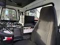 Interior view of a 2010 Autocar Xpeditor featuring a driver's seat a control panel and storage compartments