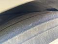 Close-up of a worn tire from a 2018 Grande West Vicinity showing tread patterns and surface texture