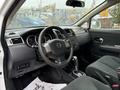 Interior of a 2012 Nissan Versa featuring a steering wheel dashboard and modern controls