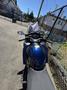 A blue 2016 Yamaha FJR1300AE motorcycle viewed from the front showing handlebars mirrors and a windshield