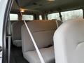 Interior of a 2013 Ford E-350 showing gray seats with seatbelts and a spacious layout for passengers