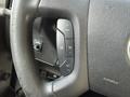 The steering wheel of a 2017 Chevrolet Express showing control buttons for cruise control and other functions
