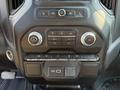 The dashboard control panel of a 2022 GMC Sierra 1500 featuring climate control buttons knobs and various dashboard switches