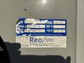 A blue label affixed to a gray surface displaying information about a 2011 International 7500 including model number serial number and documentation details