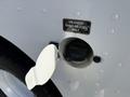 Close-up of a fuel door on a 2017 Freightliner MT45 showing a label that reads Unleaded Gasoline Fuel Only