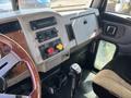 Interior cabin of a 2008 Peterbilt 340 featuring a wooden steering wheel dashboard controls and gear shift.