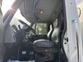 The interior of a 2012 International DuraStar 4300 showing the driver's seat steering wheel and dashboard controls