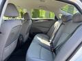 A 2015 Hyundai Sonata with a gray interior featuring spacious back seats and seatbelts in place