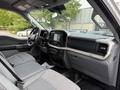 Interior of a 2021 Ford F-150 featuring a spacious cabin with gray seating a central touchscreen display and modern dashboard controls