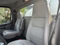 Interior view of a 2010 Freightliner M2 106 showing two gray leather seats with a simple design and one seatbelt on the driver's side