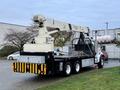 A 2004 Sterling LT9500 truck equipped with a National Crane boom lift mounted on the back