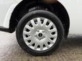 Close-up of a silver alloy wheel with six lug nuts mounted on a black tire labeled Rovelo with tread pattern visible