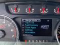A dashboard display of a 2014 Ford F-150 showing the gauge mode with information on trip, fuel economy, truck apps, settings, and a mileage indication of 92064.8 km