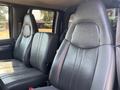 Interior view of the front seats of a 2005 GMC C7500 Topkick featuring two leather bucket seats in gray upholstery