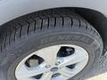 A close-up of a 2014 Ford Escape tire showing the tread pattern and the branding of the tire which is General AltiMAX