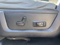 A close-up of the driver's seat adjustment controls in a 2014 RAM 5500 featuring buttons for reclining and lumbar support