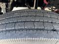 Close-up of a large, worn tire showcasing tread patterns and grooves typical of a 2019 Freightliner M2 106 vehicle