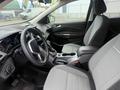 Interior of a 2014 Ford Escape showing the front seats and dashboard with a steering wheel and center console