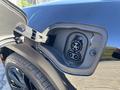 Close-up of the charging port on a 2023 Fisker Ocean showing dual charging connectors for electric vehicle charging