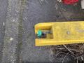 A yellow 8-foot trailer with a green valve attached near the end of the trailer's reinforcing structure