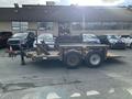 A 2013 JLG Industries Flat Deck Trailer with two axles and a wooden deck visible in the foreground